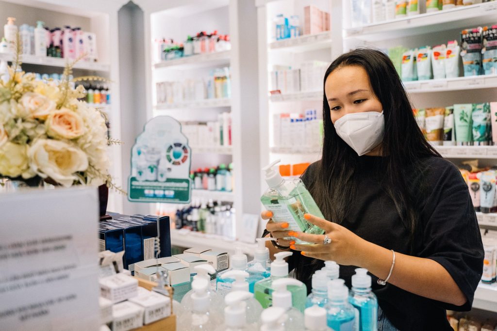 woman checking ingredients on hand sanitizer